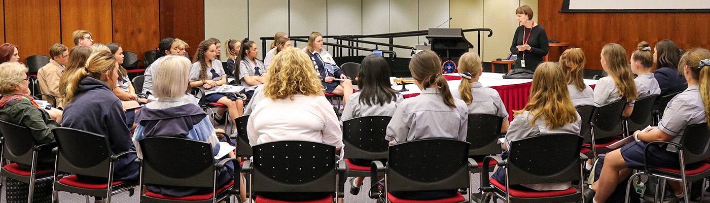 Group of students listening to teacher